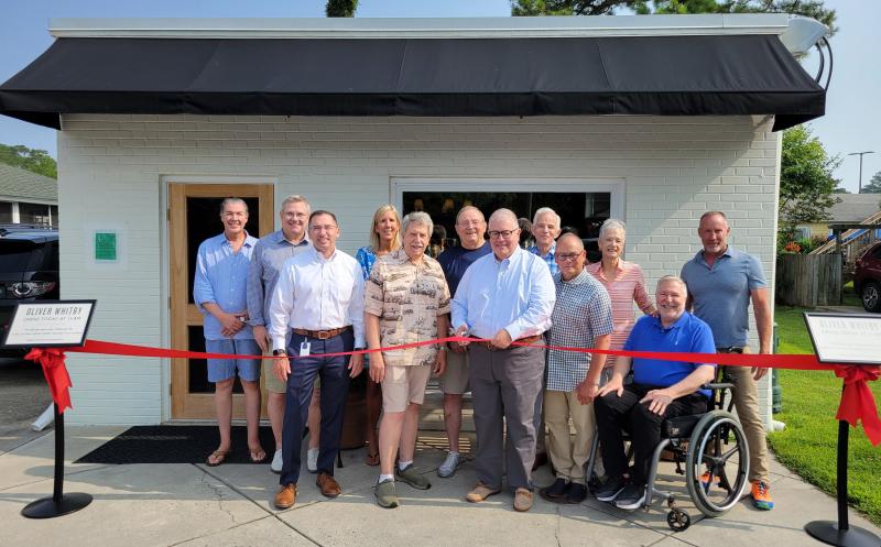 Don Preston celebrates the opening of Oliver Whitby with a ribbon cutting June 30. Shown are (l-r) Richard Blobe, Commissioner Tim Bennett, City Manager Laurence Christian, Karen Schaefer, Commissioner Francis “Bunky” Markert, Commissioner Jay Lagree, owner Don Preston, Commissioner Patrick Gossett, Frank Torres, Kate Markert, Howard Menaker and Michael Scott. CHRIS FLOOD PHOTO